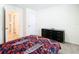 Bedroom with dark dresser and patterned bedding at 13292 Golden Lime Ave, Spring Hill, FL 34609