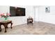 Living room featuring tile floors and a large TV at 13292 Golden Lime Ave, Spring Hill, FL 34609