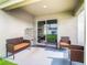 Covered patio with wicker furniture and birdcage at 13292 Golden Lime Ave, Spring Hill, FL 34609