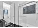 Elegant bathroom with a glass shower and view into bedroom at 15908 Castle Park Ter, Lakewood Ranch, FL 34202