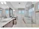 Luxurious bathroom with double vanity, soaking tub, and glass shower at 15908 Castle Park Ter, Lakewood Ranch, FL 34202