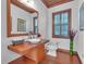 Stylish powder room featuring wood vanity and a toilet at 15908 Castle Park Ter, Lakewood Ranch, FL 34202