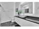 Modern bathroom with black granite vanity and a walk-in shower at 15908 Castle Park Ter, Lakewood Ranch, FL 34202