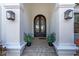 Elegant entryway with double iron doors and tile flooring at 15908 Castle Park Ter, Lakewood Ranch, FL 34202