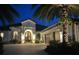 Luxury home exterior at night with lighting at 15908 Castle Park Ter, Lakewood Ranch, FL 34202
