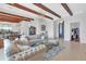 Living room with exposed beams, comfortable seating, and views at 15908 Castle Park Ter, Lakewood Ranch, FL 34202