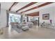 Spacious living room with exposed beams and view of kitchen and entryway at 15908 Castle Park Ter, Lakewood Ranch, FL 34202