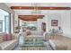 Living area with exposed beams, comfortable seating, and views at 15908 Castle Park Ter, Lakewood Ranch, FL 34202
