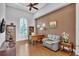 Home office with hardwood floors, built-in shelving, and comfortable seating at 15908 Castle Park Ter, Lakewood Ranch, FL 34202