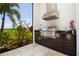 Outdoor kitchen with stainless steel appliances and golf course view at 15908 Castle Park Ter, Lakewood Ranch, FL 34202