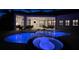 Night view of a relaxing pool and spa with patio furniture under a covered lanai at 15908 Castle Park Ter, Lakewood Ranch, FL 34202