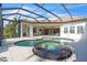 Luxury pool and spa with covered patio, outdoor kitchen, and beautiful landscaping at 15908 Castle Park Ter, Lakewood Ranch, FL 34202