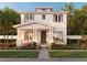 Inviting two-story home featuring a covered porch, complemented by lush landscaping and a well-manicured lawn at 2823 4Th N Ave, St Petersburg, FL 33713