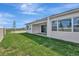 Backyard view highlighting ample green space, modern design, and outdoor living potential at 8328 Golden Beach Ct, Parrish, FL 34219