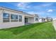 Spacious backyard featuring lush green grass and a covered patio perfect for outdoor relaxation at 8328 Golden Beach Ct, Parrish, FL 34219