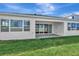 Home exterior with large windows and a sliding glass door leading to the outdoor patio at 8328 Golden Beach Ct, Parrish, FL 34219