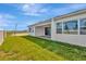 Home exterior showcasing backyard with grassy lawn at 8328 Golden Beach Ct, Parrish, FL 34219