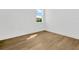 Bright bedroom with wood-look floors and a window offering natural light at 8328 Golden Beach Ct, Parrish, FL 34219