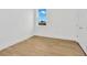 Simple bedroom with light wood flooring and a window at 8328 Golden Beach Ct, Parrish, FL 34219