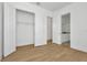 Bedroom with double doors to a closet and bathroom, and wood-look floors at 8328 Golden Beach Ct, Parrish, FL 34219