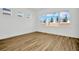 Spacious bedroom with multiple windows and wood-look tile floors at 8328 Golden Beach Ct, Parrish, FL 34219