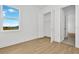 Spacious bedroom with large window and light wood floors at 8328 Golden Beach Ct, Parrish, FL 34219