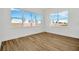 Bright bedroom with large windows and wood-look tile flooring at 8328 Golden Beach Ct, Parrish, FL 34219