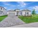 Elegant single-story home with a neatly paved driveway and manicured front lawn at 8328 Golden Beach Ct, Parrish, FL 34219