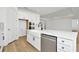 White kitchen with farmhouse sink, stainless steel appliances, and an island at 8328 Golden Beach Ct, Parrish, FL 34219