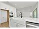 Modern kitchen with white cabinets, a farmhouse sink, and stainless steel dishwasher at 8328 Golden Beach Ct, Parrish, FL 34219