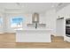 Modern kitchen with white cabinets, island, and stainless steel appliances at 8328 Golden Beach Ct, Parrish, FL 34219