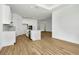 Open concept kitchen with island, white cabinets, and wood-look tile floors at 8328 Golden Beach Ct, Parrish, FL 34219