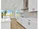 Modern kitchen with white cabinets, quartz countertops, and stainless steel appliances at 8328 Golden Beach Ct, Parrish, FL 34219