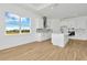 Modern kitchen with white cabinets, island, and a view from the window at 8328 Golden Beach Ct, Parrish, FL 34219