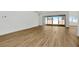 Open living area with wood-look tile floors and sliding glass doors to backyard at 8328 Golden Beach Ct, Parrish, FL 34219