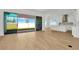 Bright living room with sliding glass doors leading to backyard and modern tile floors at 8328 Golden Beach Ct, Parrish, FL 34219