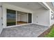 Covered patio with pavers and sliding glass doors leading to the interior at 8328 Golden Beach Ct, Parrish, FL 34219