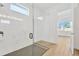 Large walk-in shower with marble tile and hexagonal floor at 8328 Golden Beach Ct, Parrish, FL 34219