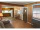 View of living room, dining area, and kitchen with wood paneling at 39047 Ola Ave, Zephyrhills, FL 33542