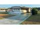 Mobile home with carport and landscaped yard at 39047 Ola Ave, Zephyrhills, FL 33542