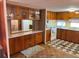Kitchen with wood cabinets, tiled floor, and built-in microwave at 39047 Ola Ave, Zephyrhills, FL 33542
