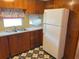 View of kitchen sink and appliances with wood cabinets at 39047 Ola Ave, Zephyrhills, FL 33542