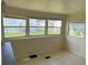 Sunroom with multiple windows and patterned flooring at 39047 Ola Ave, Zephyrhills, FL 33542