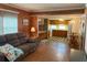 Open living area with wood paneling and access to kitchen at 39047 Ola Ave, Zephyrhills, FL 33542