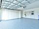 Garage with storage cabinets and epoxy floor at 1810 Haverford Ave, Sun City Center, FL 33573