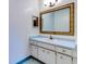 Bathroom with light wood vanity and large mirror at 1810 Haverford Ave, Sun City Center, FL 33573