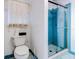 Bathroom with toilet, shower, and tiled floor at 1810 Haverford Ave, Sun City Center, FL 33573
