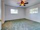 Spacious bedroom with carpeted floors and ceiling fan at 1810 Haverford Ave, Sun City Center, FL 33573