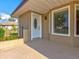 Front porch with white door and window at 1810 Haverford Ave, Sun City Center, FL 33573