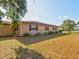 House side yard with well-manicured lawn and landscaping at 1810 Haverford Ave, Sun City Center, FL 33573
